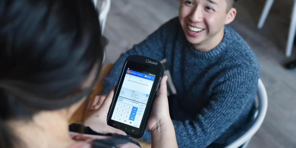 a-person-accepts-payments-using-toast